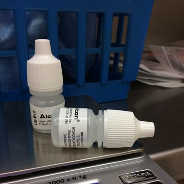 Eye drop dispensers sitting on a scale